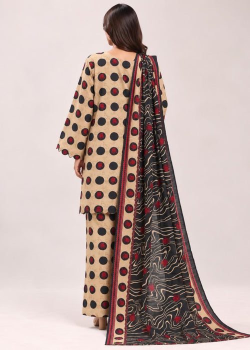 A woman shown from the back wearing a beige traditional outfit with large black and red polka dots, matching pants, and a long black dupatta with red and beige patterns, against a plain light background.