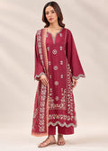 A woman modeling a traditional Indian salwar kameez set in deep maroon, featuring intricate white and gold floral embroidery, a matching dupatta, and matching trousers, set against a neutral beige studio background.
