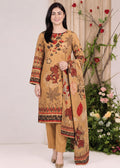 A woman modeling a traditional three-piece salwar kameez suit in beige with a red, brown, and black floral print, standing in front of a neutral studio backdrop with decorative plants.