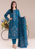 A woman models a teal blue ethnic salwar kameez suit with intricate white and purple floral prints, paired with matching trousers and a dupatta, set against a neutral beige background with a bicycle prop.