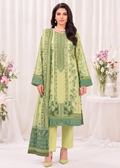 A woman models a three-piece traditional South Asian salwar kameez suit in light green and forest green. The long kurta features intricate floral prints, vertical border patterns, and a matching printed dupatta, paired with light green trousers and green heels, set against a draped white curtain backdrop with floral arrangements.