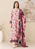 A woman models a traditional three-piece salwar kameez suit set. The set features a white kurta with red floral prints, matching red and black patterned trousers, and a coordinating dupatta with red, black, and white geometric and floral patterns.