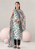 A woman models a three-piece printed salwar kameez suit set with a matching dupatta. The set features a white base with green, pink, and black floral patterns, paired with black pants and black sandals, set against a light gray background with decorative pink spheres.
