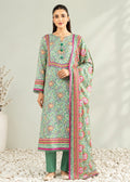 A woman models a traditional three-piece salwar kameez suit set. The set features a mint green printed kurta with pink and orange floral motifs, matching green trousers, and a coordinating dupatta with a vibrant pink and green border.