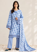 A woman models a light blue three-piece traditional outfit with a matching dupatta. The set features a long-sleeved tunic with blue floral prints and embroidered borders, light blue pants, and a matching sheer dupatta with a blue geometric pattern.