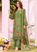 A woman models a three-piece olive green ethnic salwar kameez suit with colorful floral embroidery, paired with matching wide-leg trousers and a sheer embroidered dupatta, set against a pink garden-themed backdrop.